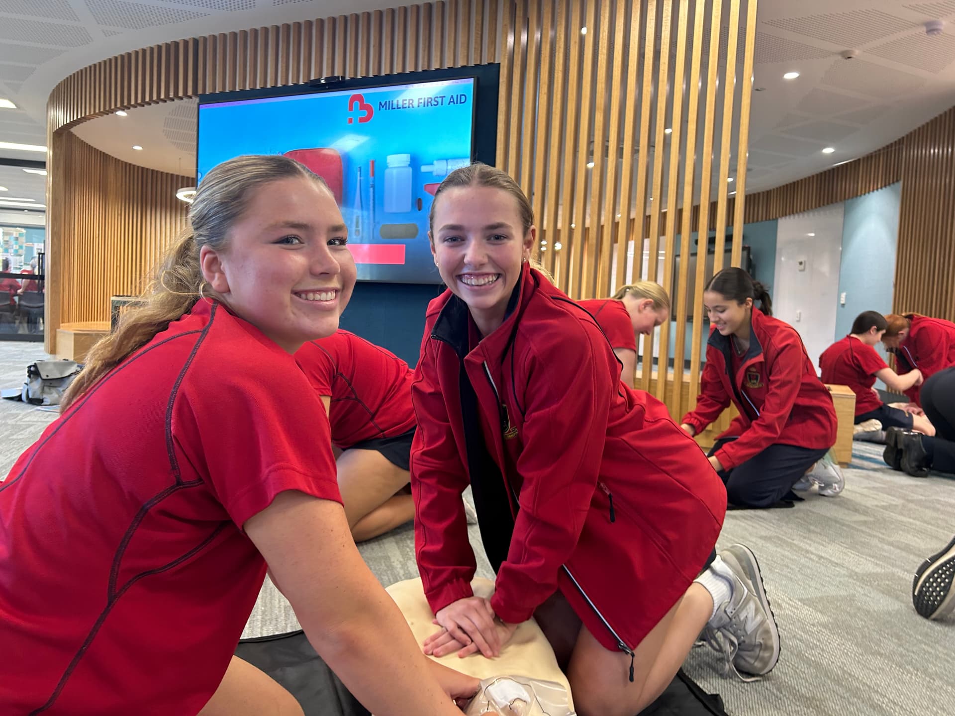 Students participating in first aid training at school